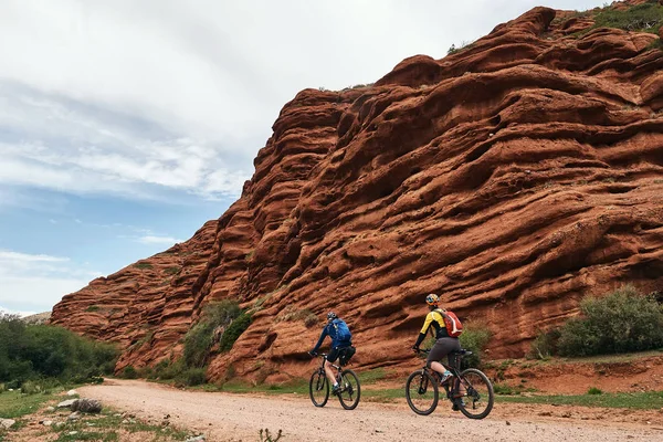 Two Cyclist Riding Amazing Red Mountain Range Jeti Oguz Seven Royalty Free Stock Photos