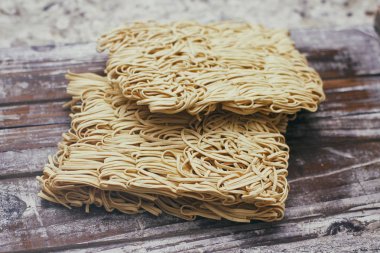 Ahşap gıda standı üzerinde kuru çiğ yumurta erişte seti. Hazır erişte pişirmeye hazır. 