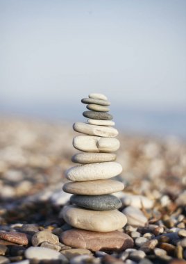 Bulanık arka plan üzerinde taşlar dengesi piramidi. Kule ortada. Zen bahçesi. Spa seti