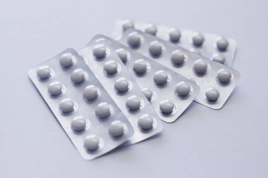 White pills plastic blisters on white background. 