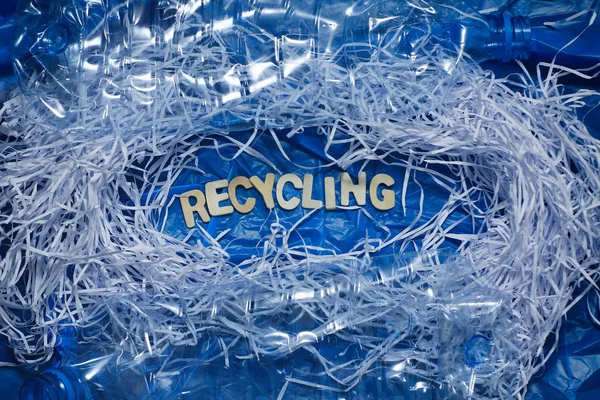 Waste recycle concept. Paper and plastic garbage. Blue background.