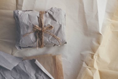 Yumuşak parsel eski zanaat kağıt ve kravat içine sarılmış. Buruşuk arka plan dokusu. Hediyelik eşya dükkanı. Nakliye ve nakliye malzemeleri.