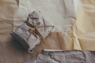 Yumuşak parsel eski zanaat kağıt ve kravat içine sarılmış. Buruşuk arka plan dokusu. Hediyelik eşya dükkanı. Nakliye ve nakliye malzemeleri.