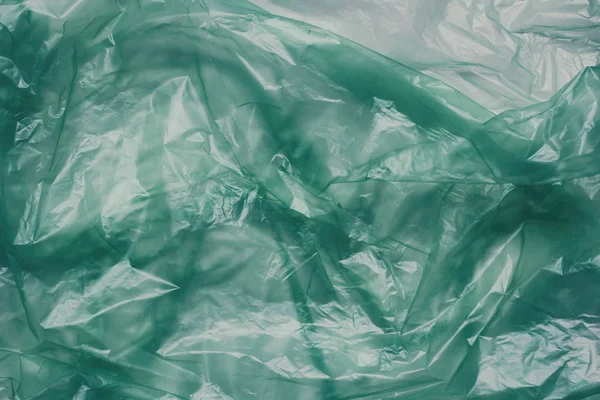 Plastic green bag texture background. Crumpled polyethylene texture. Waste recycle concept.