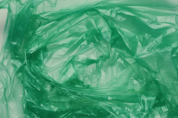 Plastic green bag texture background. Crumpled polyethylene texture. Waste recycle concept.