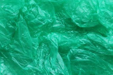 Yeşil buruşturulmuş plastik torba doku arka plan. Atık geri dönüşüm konsepti. Polietilen berrak çöp torbaları. 