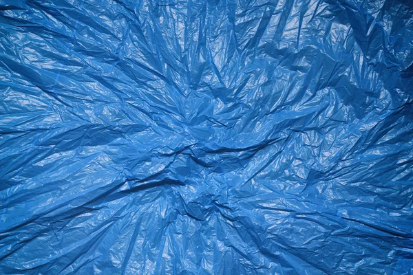 Blue plastic bag texture background. Waste recycling concept. Crumpled polyethylene and cellophane.