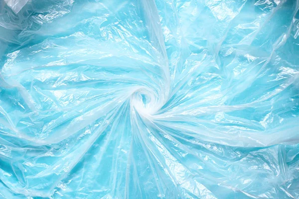 Transparent plastic bag swirl. Whirlpool from clear plastic bag. Background texture. Waste recycle. Reuse of trash.