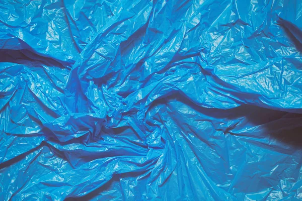 Mavi plastik torba doku arka plan. Atık geri dönüşüm konsepti. Buruşturulmuş polietilen ve selofan.