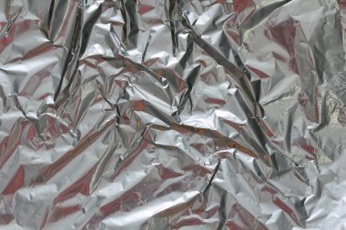 Buruşuk folyo doku arka plan. Metal kağıt boku. Gümüş alüminyum yüzey. Hediye parlak kağıt sarma. Glitter etkisi.