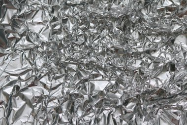 Buruşuk folyo doku arka plan. Metal kağıt boku. Gümüş alüminyum yüzey. Hediye parlak kağıt sarma. Glitter etkisi.