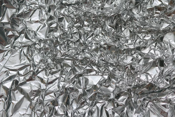 Buruşuk folyo doku arka plan. Metal kağıt boku. Gümüş alüminyum yüzey. Hediye parlak kağıt sarma. Glitter etkisi.