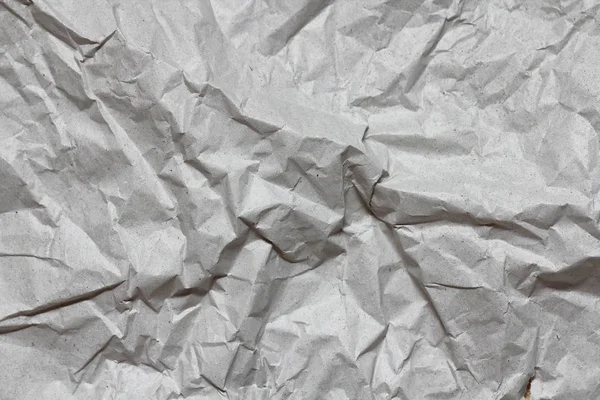 Crumpled gray craft paper texture background. Package wrapping. Old wrapping paper. Baking parchment. Letter template.