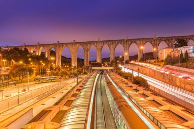View of The Aguas Livres Aqueduct and Campolide train station, Lisbon, Portugal clipart