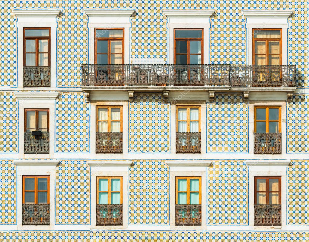 Facade of a building covered with traditional Portuguese tiles. Typical building decoration in Lisbon, Portugal