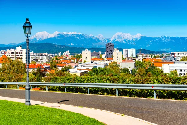 Picturesque cityscape of a European modern city with a beautiful mountain range in the background — Stock Photo, Image