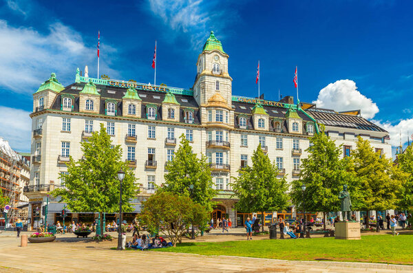 Oslo - June 2019, Norway: View of the Grand Hotel Oslo building with blue sky in the background