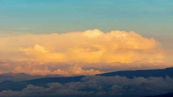 Puesta Sol Con Silueta Montaña Rodeada Nubes Amarillas Cielo Azul — Foto de Stock