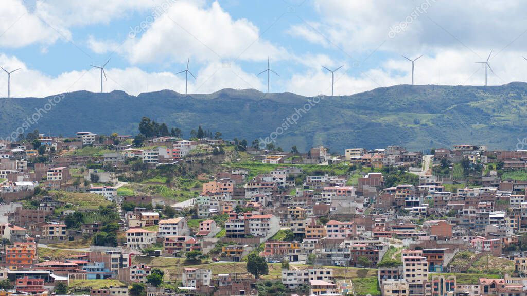 Panoramic view of the city of Loja in Ecuador with wind turbines on the horizon