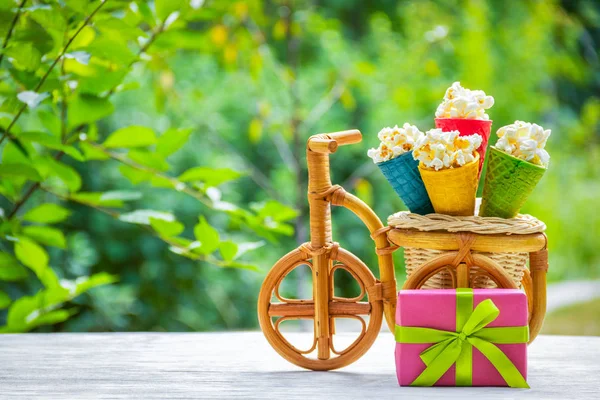 Popcorn and waffle cones. Sweets and gifts. Festive decorations. Gift box and popcorn. Copy space