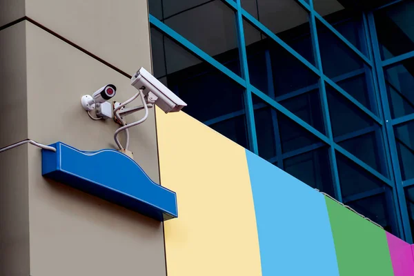 Surveillance camera on the corner of the house. Security and control