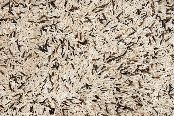 White and black raw rice close-up. Cereals, cooking.