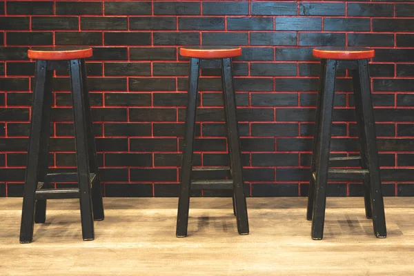 Black bar stools with a red seat. Bar furniture. The interior of the bar. Furniture for the reception.