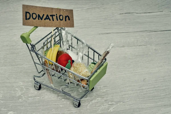 Donations food. Help products during a pandemic, charity. Cart with products.