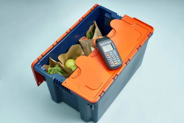 Plastic box with products. Food delivery in platinum boxes. Safe delivery. Storage of fragile goods.