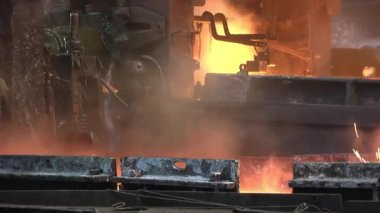 Metalurji tesisinde konveyör üzerinde sıcak çelik ray