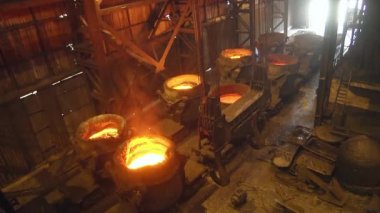 Dönüştürücü içine dökme katmak için kovalarda dökme demir. Metalürji tesisinde konvertör üretimi.