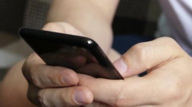 Modern Akıllı Telefon Tutan Mans Hands yakın. Siyah metalik mobil cihazda mesaj atan bir adamın elleri. 5g ve 4g ağlar için cep telefonu kullanımı ve bağlantı. Yumuşak odaklama