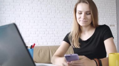 Genç beyaz uzun saçlı kız portresi gülümseyerek ev-ofis kameraya akıllı telefon yeşil ekran gösteren. 