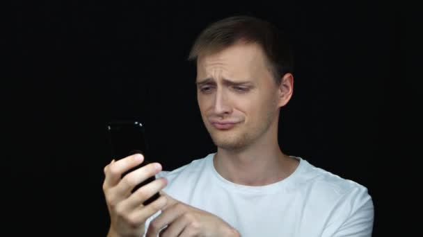 Young Sad Caucasian Man Chatting Phone Isolated Black Background Close — Stock Video