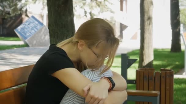 Depressed Sad Handsome Young Caucasian Woman Eyeglasses Sitting Alone Bench — Stock Video