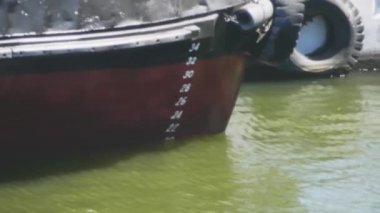 Ticaret gemisindeki dalgalanmaların ve dalgaların yansıması. Gün batımında geminin panosunda güneş ışığı su yansımaları. Sakinlik ve huzur, yakın çekim. 