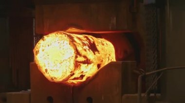 Erimiş metal boş. Kütük demirci basında dövülür. Makine Dökümhane'de Parlayan Çelik Çubuğu Çekiçler. karanlık atölyede çok sıcak demir bar demir demirci demirci demirci kadar kaybetmek.