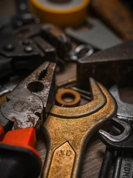 Building and measuring tools. Set of tools over a wood panel. Construction Tools With Blueprint On Wooden Desk