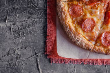 Lezzetli biberli pizza ve siyah beton arka planda domates fesleğeni. Acı biberli pizzanın en iyi manzarası. Metin için kopyalama alanı ile. Düz yatıyordu