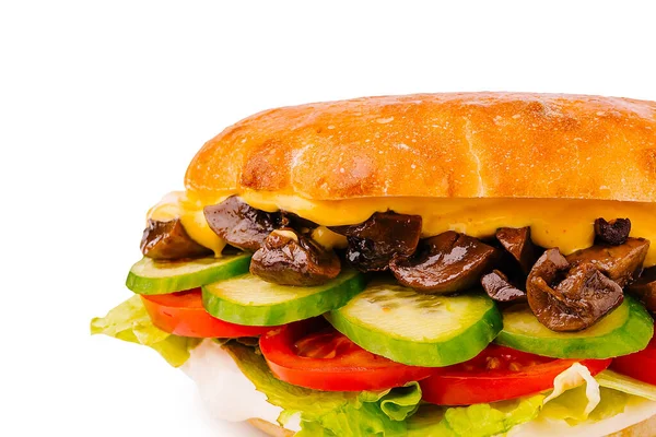 İçinde sotelenmiş mantarlar, kıtır marul, taze domates ve salatalık dilimleri olan doyurucu bir sandviç, hepsi yumuşak bir çöreğin içinde.