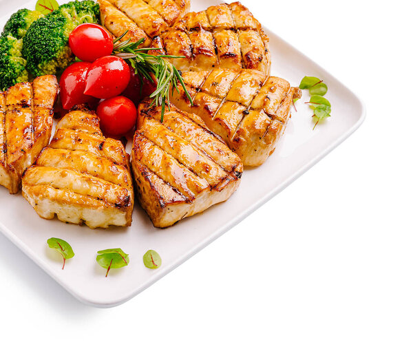 Juicy grilled salmon fillets are neatly arranged with vibrant broccoli and cherry tomatoes. This appetizing dish showcases fresh ingredients, ideal for a healthy meal.