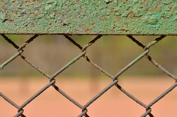 A fence made of iron net.The wire is twisted into a rigid mesh .