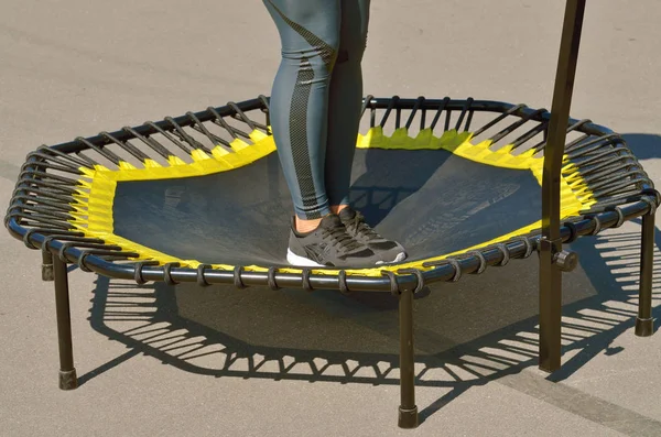 Jumping on an elastic trampoline.This exercise develops coordination.Legs get stronger.