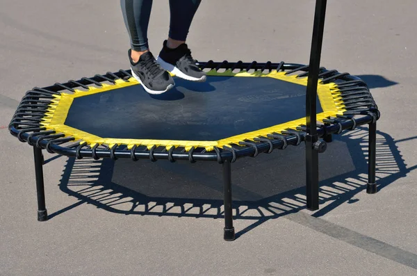 Jumping on an elastic trampoline.This exercise develops coordination.Legs get stronger.