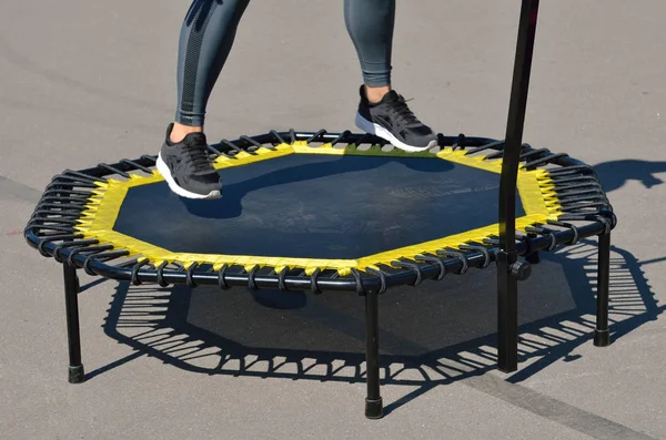 Jumping on an elastic trampoline.This exercise develops coordination.Legs get stronger.