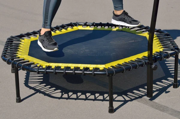 Jumping on an elastic trampoline.This exercise develops coordination.Legs get stronger.