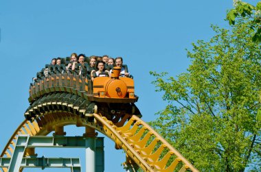 Saint-Petersburg.Russia. may. 20.2018. Kresovsky island.Divo island Park.A popular attraction is the Russian roller coaster.It is a railway system of special design.Passengers traveling in railcar at high speed. clipart