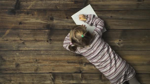 Overhead child girl writing santa claus gift letter on vintage wooden background.Text or logo copy space.Vertical top view.Social card for Christmas or winter holiday season.4k video — Stock Video