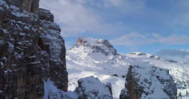 İleri hava görkemli Cinque Torri kayalık aracılığıyla gösteren kayak pistlerine bağlar. Bulutlu gökyüzü güneşli gün. Kış Dolomites İtalyan Alpleri dağlar açık doğa establisher.4k drone uçuş