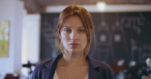 Confident redhead young woman serious and smiling portrait.Corporate busineswoman,freelancer,small business owner at studio office, coworking.People wearing casual.Professional,growth,success.4k video — Stock Video